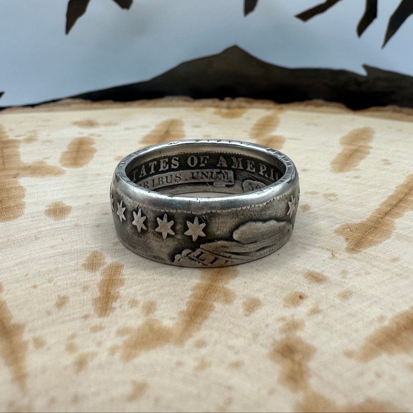 U.S. (Rare) Capped Bust Liberty Silver Half Dollar Coin Ring on a wood background. - Mountainstruck Coin Jewelry