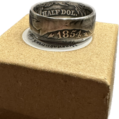 U.S. Seated Liberty Silver Half Dollar Coin Ring on a brown kraft box. - Mountainstruck Coin Jewelry