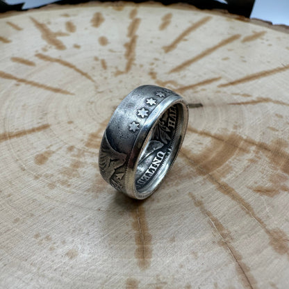 U.S. Seated Liberty Silver Half Dollar Coin Ring (patina) on a light wood round. - Mountainstruck Coin Jewelry