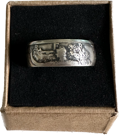 U.S. Walking Liberty Silver Half Dollar Coin Ring on a black velvet background in a brown kraft box. - Mountainstruck Coin Jewelry