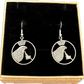 Idahome State Quarter Hand Cut Coin Earrings in a brown kraft box on a black velvet background.