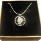 U.S. "V" Nickel Hand Cut Coin Necklace with a steel ball chain in a brown kraft box with a black velvet background.