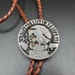 Mexico Silver 25 Pesos Hand Cut Coin Bolo Tie with darker brown leather cord on black background.