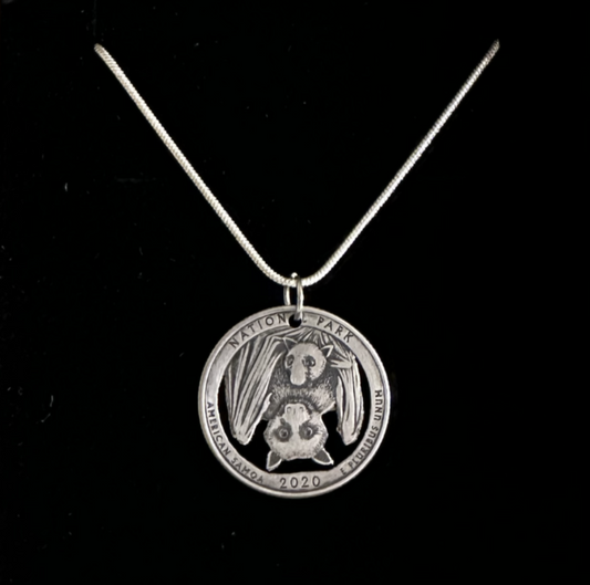 U.S. American Samoa National Park US Quarter Coin Necklace (Bats!) on a black velvet background.