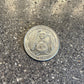 U.S. American Samoa National Park US Quarter Coin back on a concrete background.