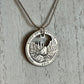 Idaho "River of No Return" Hand Cut Quarter Necklace with a snake chain on a white wood background.
