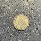 Phoenix Japan 100 Yen Silver Coin front on a concrete background.