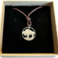 U.S. Buffalo Nickel (Reverse) Coin Necklace with a leather cord in a brown kraft box on a black velvet background.