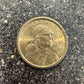 Flying Eagle Sacagawea One Dollar Coin front on a concrete background.