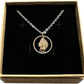 U.S. Indian Head Penny Coin Necklace with a stainless chain in a brown kraft box on a black velvet background.