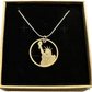 U.S. Statue of Liberty Gold Dollar Hand Cut Coin Necklace with a snake chain in a brown kraft box on a black velvet background.