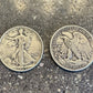 U.S. Walking Liberty Silver Coin on a concrete background. Front face of coin on the left in the picture and back side of the coin on the right.