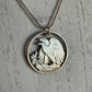 U.S. Walking Liberty Silver Hand Cut Coin Necklace (Eagle) with a snake chain on a white wood background.