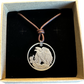 U.S. Walking Liberty Silver Hand Cut Coin Necklace (Eagle) with a leather cord in a brown kraft box on a black velvet background.