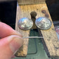 U.S. Silver Quarter Hand Crafted Coin Locket Necklace in the crafting process on a wooden block.