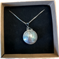 U.S. Silver Quarter Hand Crafted Coin Locket Necklace back side in a brown kraft box on a black velvet background.