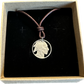 U.S. Buffalo Nickel (Front) Coin Necklace with a leather cord in brown kraft box on black velvet background.