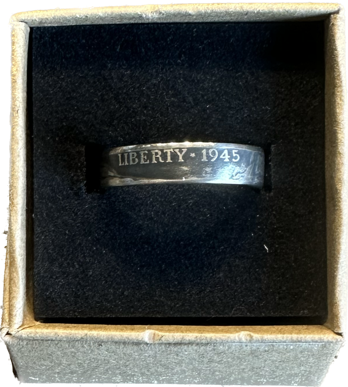 WW2 U.S. Silver Nickel Coin Ring in a brown kraft box on a black velvet background.