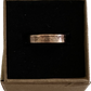 Wheat Penny Coin Ring in a brown kraft box on a black velvet background.