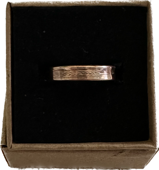 Wheat Penny Coin Ring in a brown kraft box on a black velvet background.