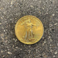 U.S. Gold Eagle 1/4 oz Fine Gold Coin back on a concrete background.