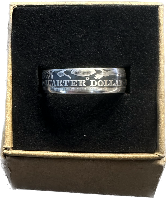 Barber Silver Quarter (reverse) coin ring in a brown kraft box on a black velvet background.