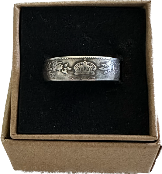 Canada 25 Cents Maple Leaf Silver Coin Ring in a brown kraft box on a black velvet background.