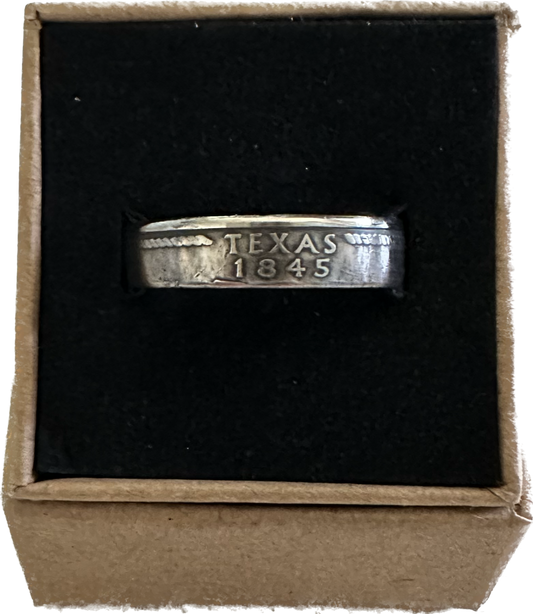 U.S. State Quarter Coin Ring featuring Texas in a brown kraft box on a black velvet background.