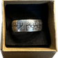 Barber Half Dollar Silver Coin Ring (reverse) in brown kraft box on a black velvet background.