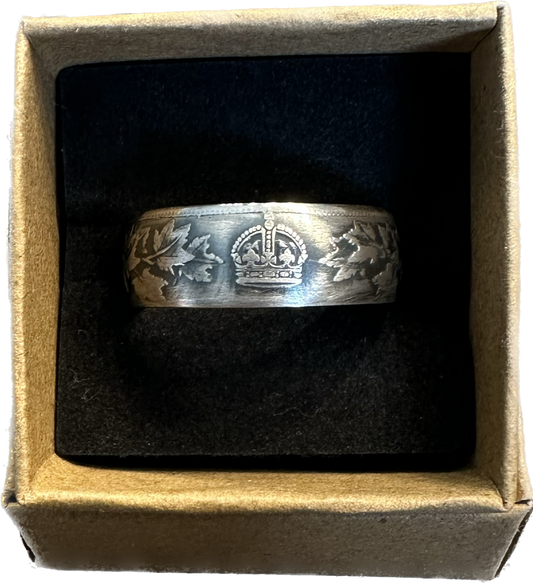 Canada 50 Cents Maple Leaf Silver Coin Ring in a brown kraft box on a black velvet background.