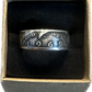 JFK Silver Half Dollar Coin Ring (front) in a brown kraft box on a black velvet background.
