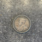 Newfoundland 50 Cents Silver Coin front on a concrete background.
