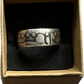 Seated Liberty Silver Half Dollar Coin Ring (patina) in a brown kraft box on a black velvet background.