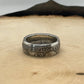U.S. 1892-1893 Chicago Columbus Silver Half Dollar Coin Ring (patina) on a light wood round with mountain outline in background.