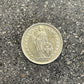 Swiss 1 Franc Silver Coin front on a concrete background.