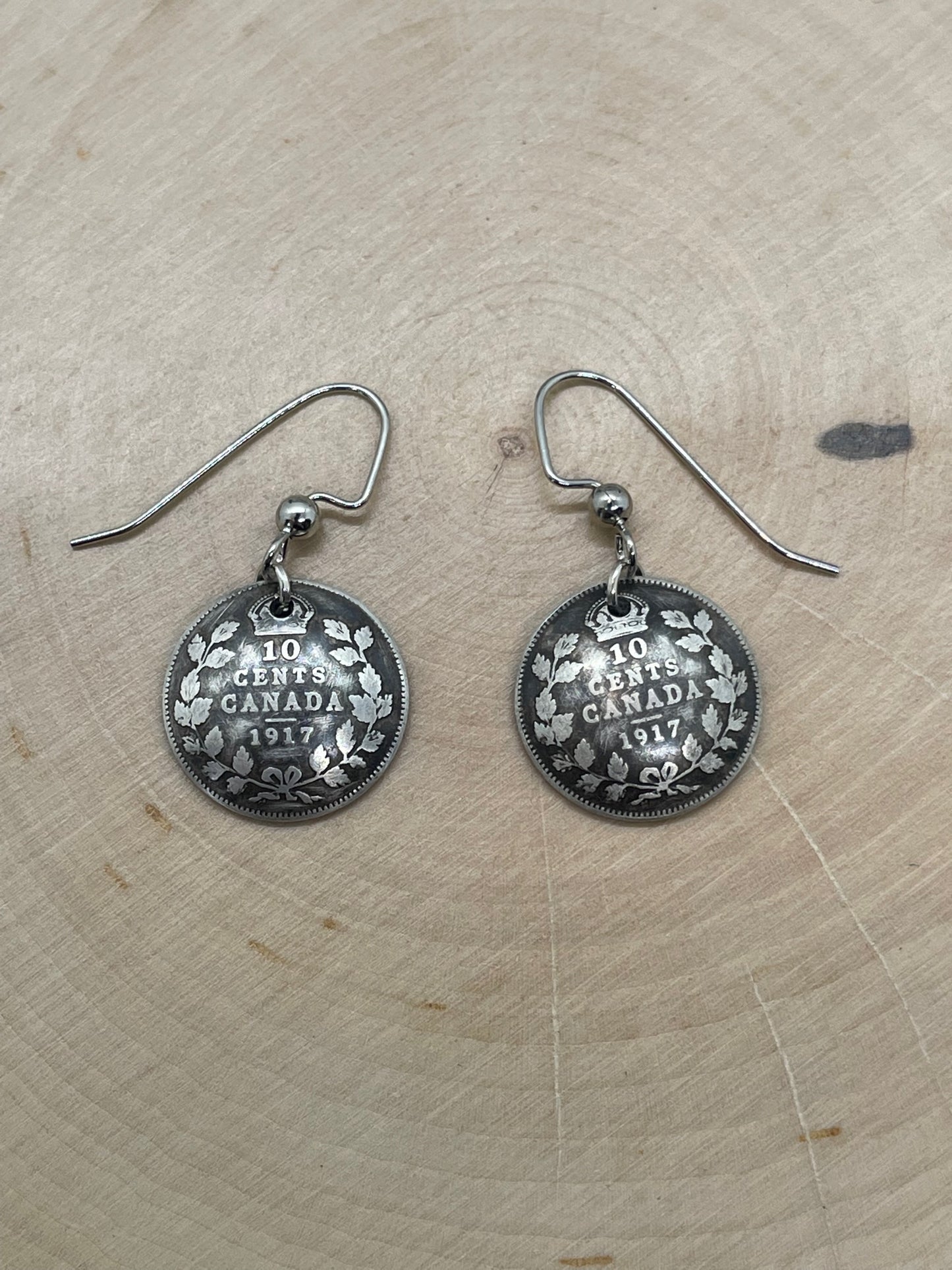 Canada 10 Cents Silver Coin Earrings on a light wood round. - Mountainstruck Coin Jewelry