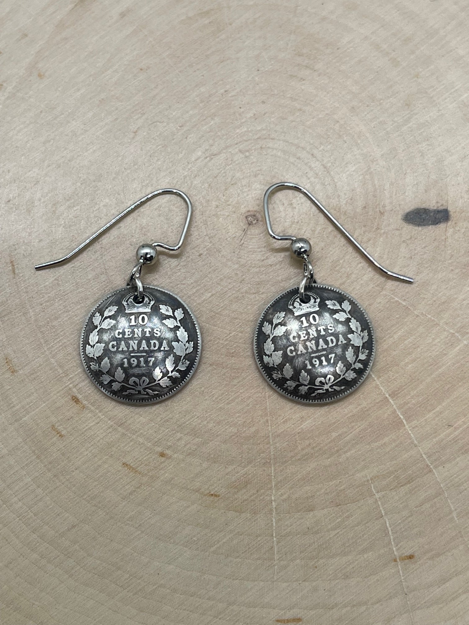Canada 10 Cents Silver Coin Earrings on a light wood round. - Mountainstruck Coin Jewelry