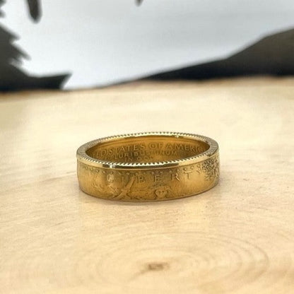 U.S. Gold Eagle 1/4 oz Fine Gold Coin Ring on a light wood background. - Mountainstruck Coin Jewelry