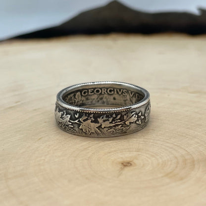 Canada 25 Cents Maple Leaf Silver Coin Ring on a light wood round. - Mountainstruck Coin Jewelry