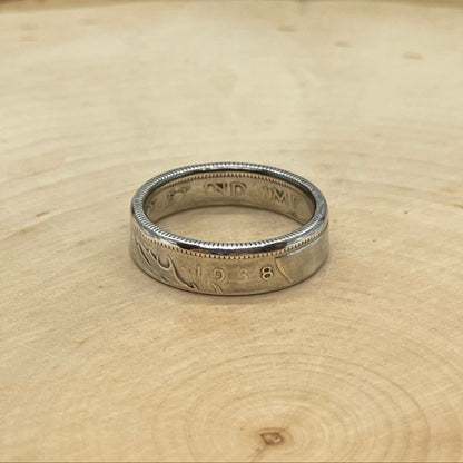 Canada 25 Cents Silver Coin Ring on a light wood round with a mountain outline background. - Mountainstruck Coin Jewelry