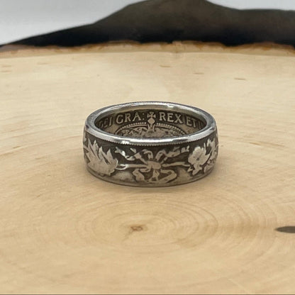 Canada 50 Cents Maple Leaf Silver Coin Ring on a light wood round with a mountain outline background. - Mountainstruck Coin Jewelry