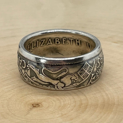 Canada 50 Cents Silver Coin Ring (Lion + Unicorn) on a light wood round. - Mountainstruck Coin Jewelry