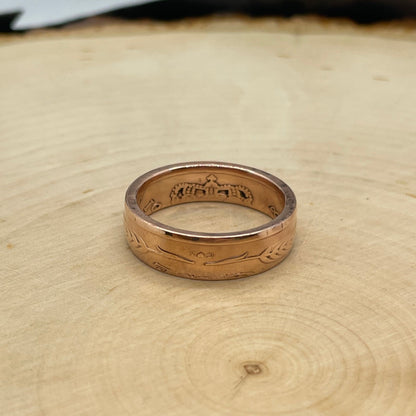 Denmark 5 Øre Coin Ring on a light wood round. - Mountainstruck Coin Jewelry