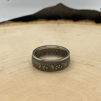 India Half Rupee Silver Coin Ring on a light wood round with mountain outline in the background. - Mountainstruck Coin Jewelry