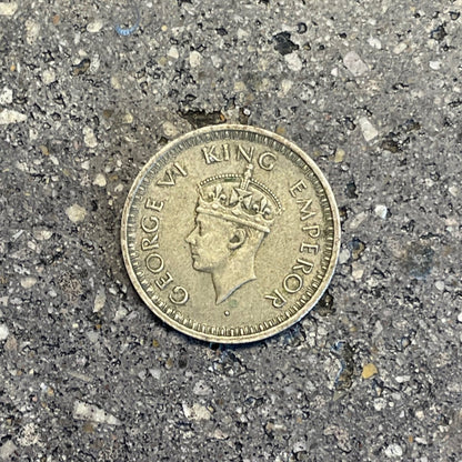 India Half Rupee Silver Coin front on a concrete background. - Mountainstruck Coin Jewelry