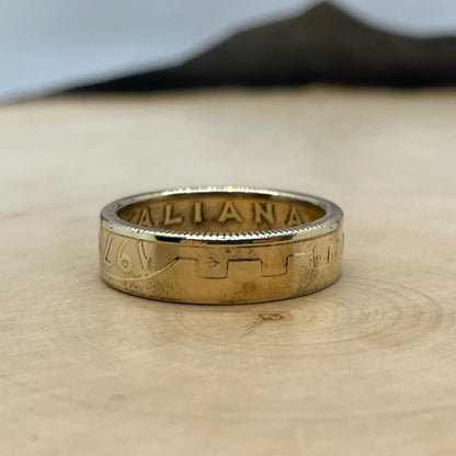 Italy 200 Lire Coin Ring on a light wood round with mountain outline in background. - Mountainstruck Coin Jewelry