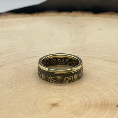 Japan 5 Yen Coin Ring on a wood round. - Mountainstruck Coin Jewelry