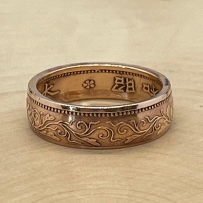 Japan One Sen Coin Ring on a light wood round. - Mountainstruck Coin Jewelry
