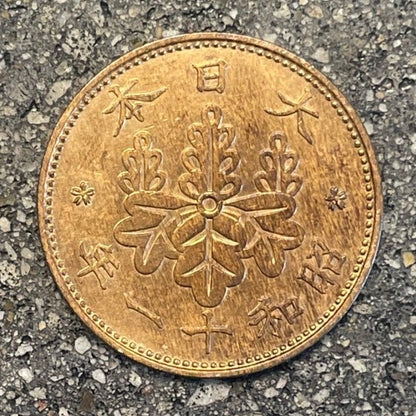 Japan One Sen Coin front on a concrete background. - Mountainstruck Coin Jewelry