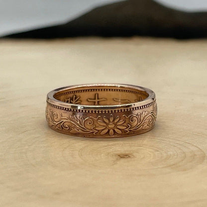 Japan Sen Coin Ring on a light wood round with mountain outline in the background. - Mountainstruck Coin Jewelry